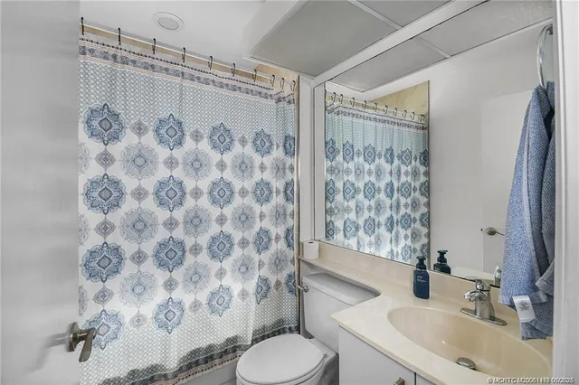 a bedroom with a bed and a mirror