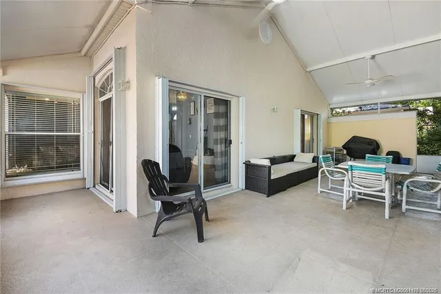 a building outdoor space with patio furniture and potted plants