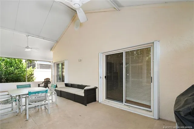 a patio with yard glass top table and chairs