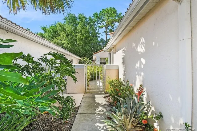an aerial view of a house with swimming pool and garden