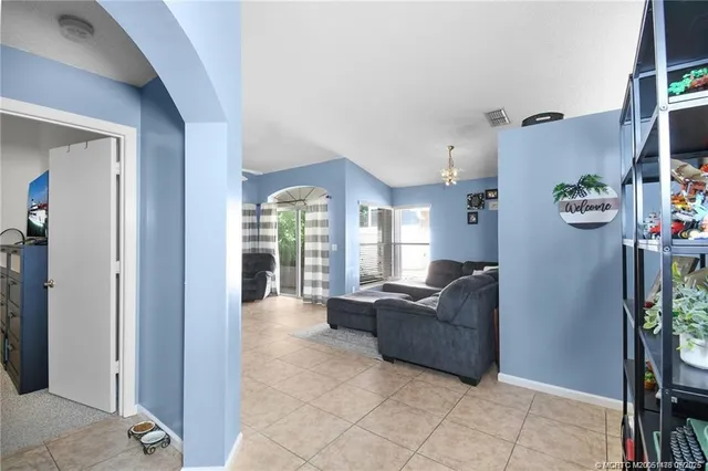 a living room with furniture and a potted plant