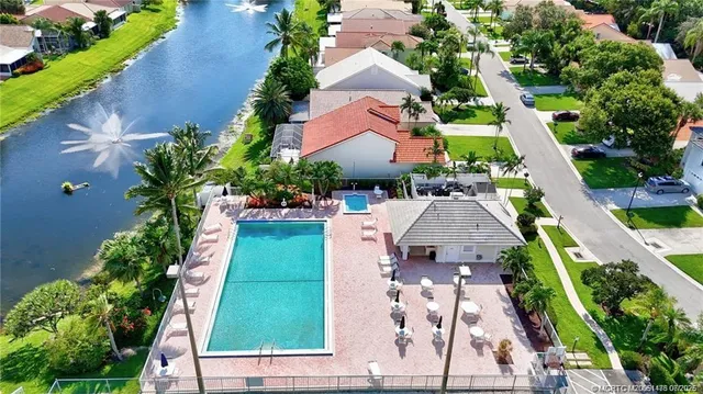 an aerial view of a house with garden space and swimming pool