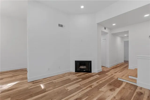 a view of empty room with a fireplace