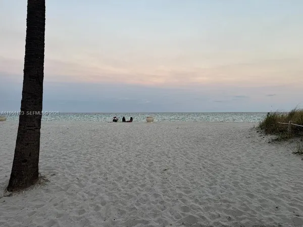 a kitchen with a stove top oven and refrigerator