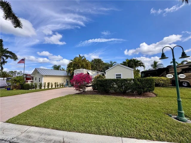 a swimming pool with yard in front of it