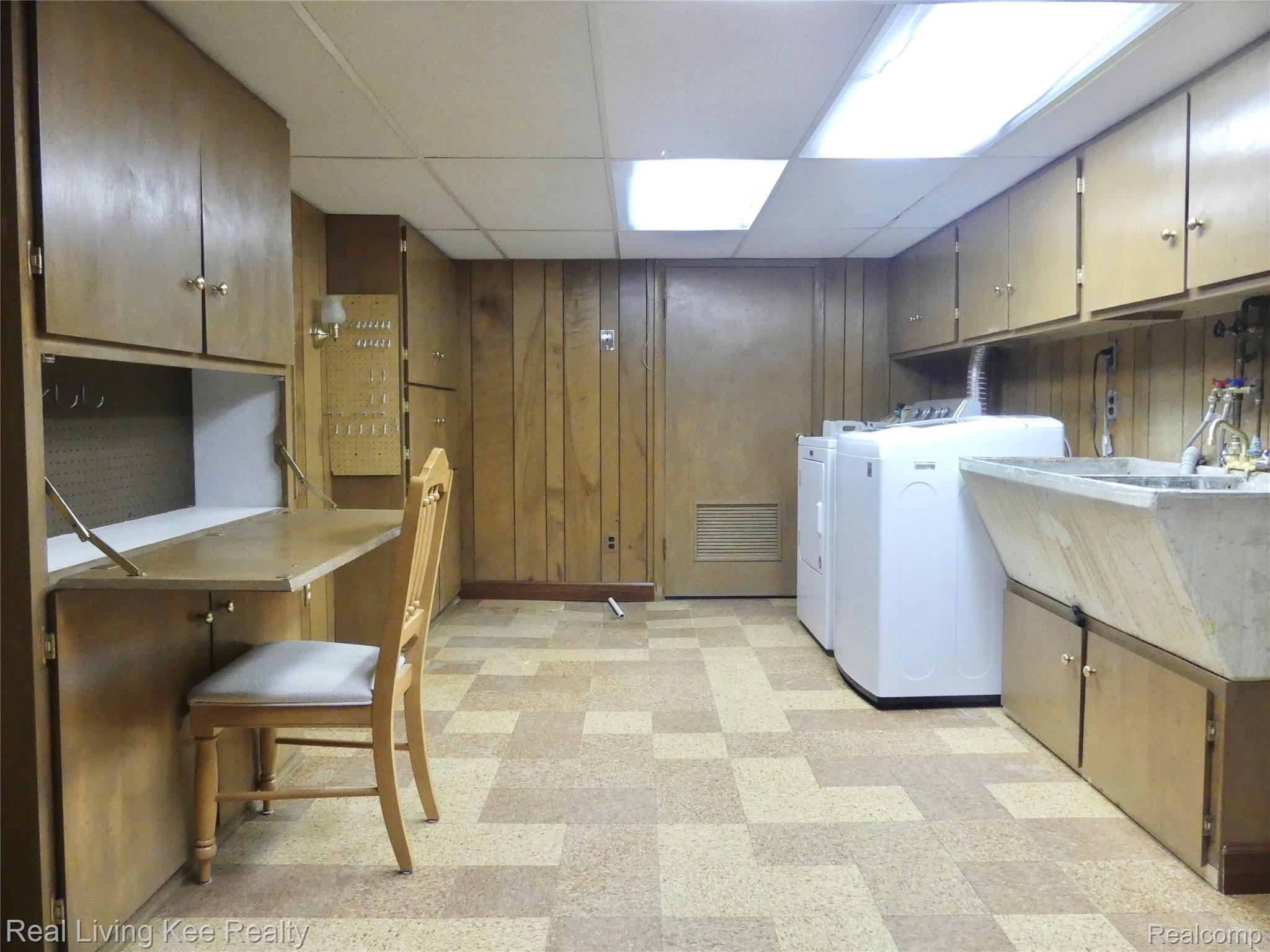 67 Cedarwald Drive Rochester, MI 48306 - Photo 43 of 49 Huge laundry area has tons of storage and drop-down desk