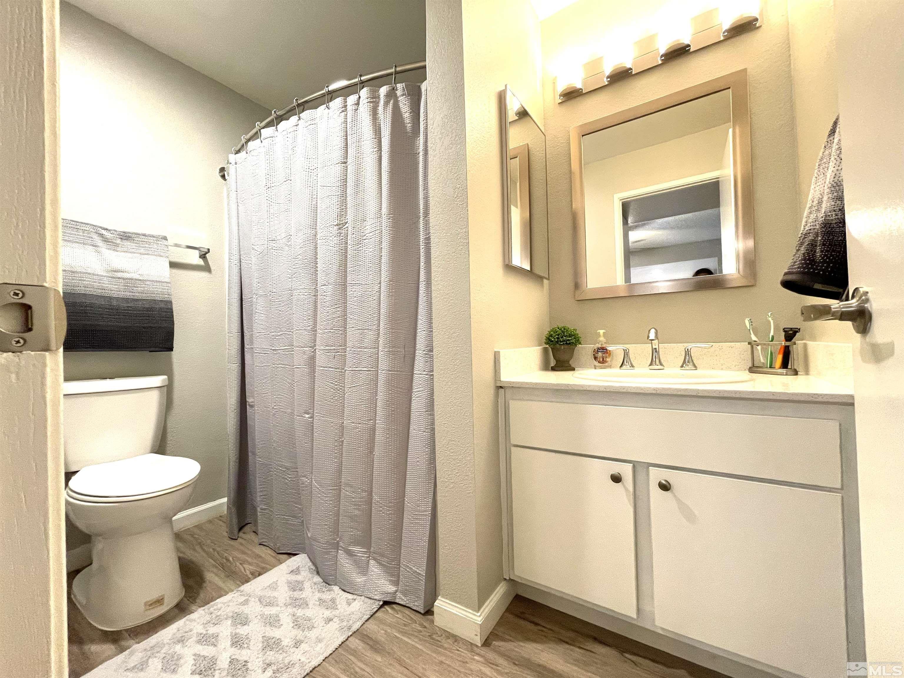 7680 Bluestone Drive, Unit 409 Reno, NV 89511 - Photo 15 of 16 a bathroom with a sink toilet and shower