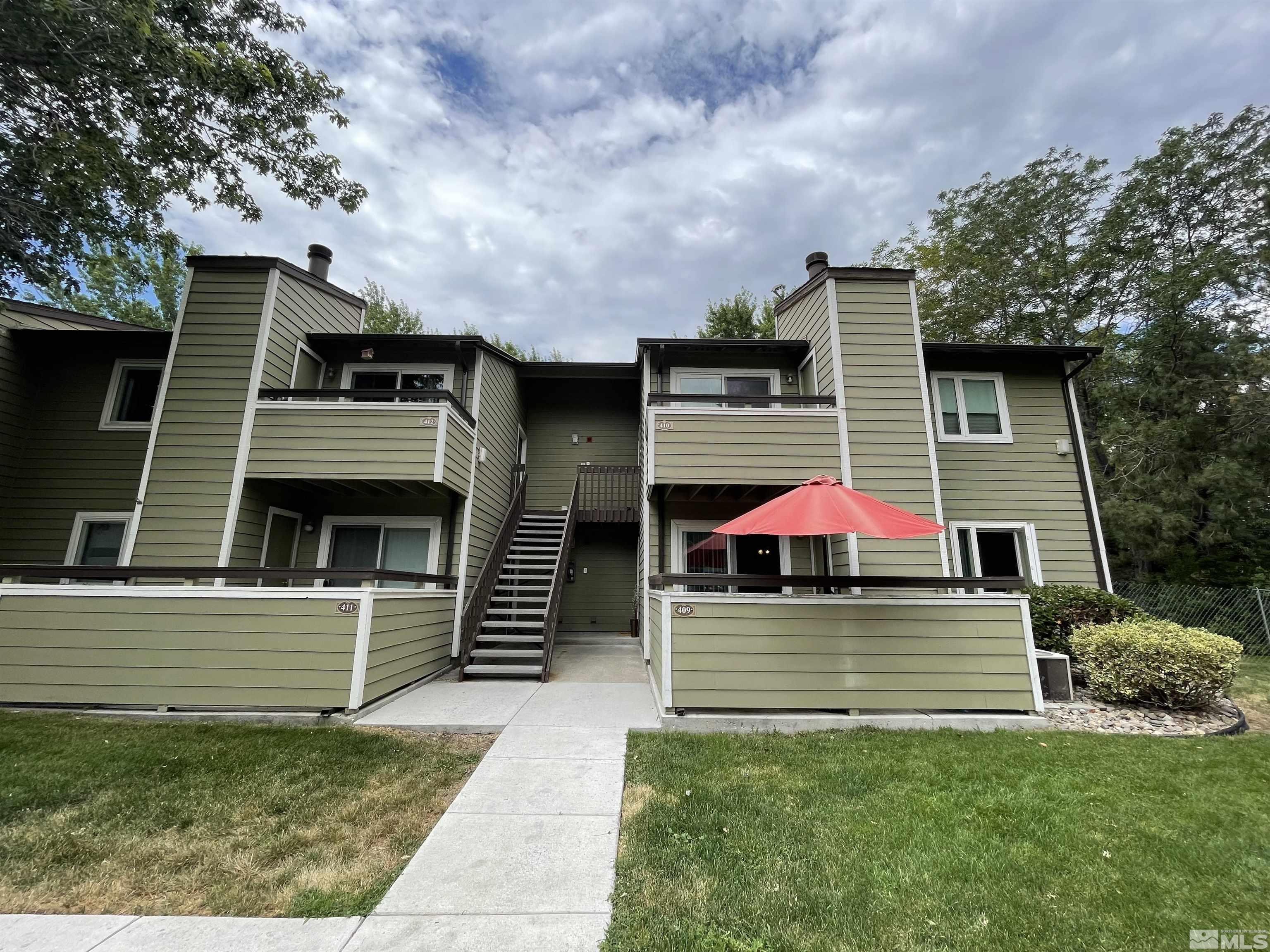 7680 Bluestone Drive, Unit 409 Reno, NV 89511 - Photo 2 of 16 a view of a house with a yard