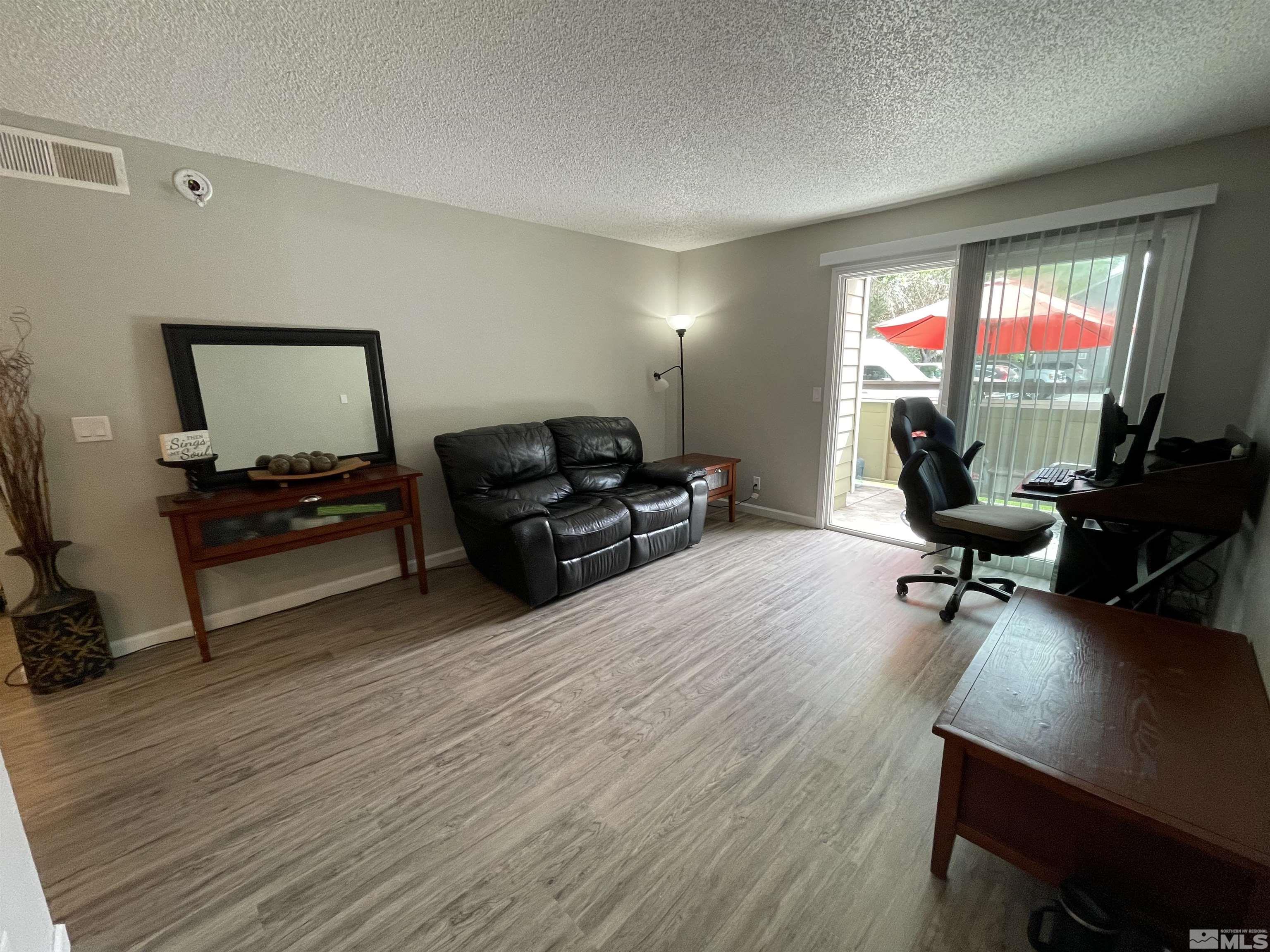 7680 Bluestone Drive, Unit 409 Reno, NV 89511 - Photo 6 of 16 a living room with furniture window and a flat screen tv