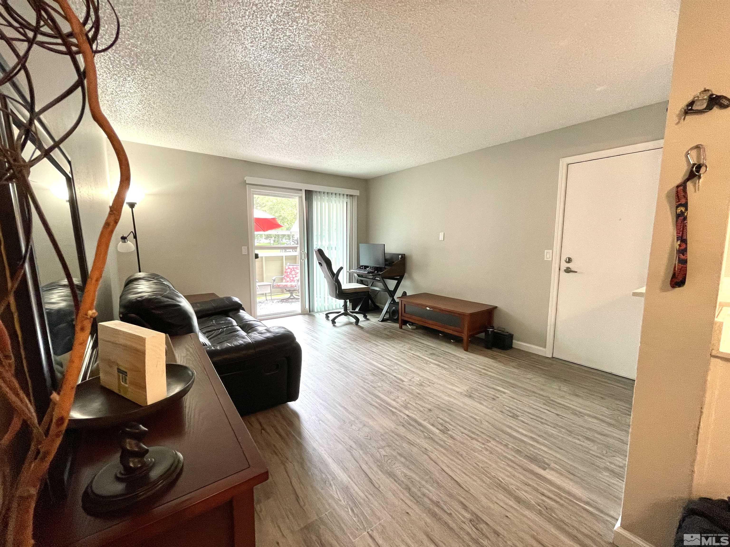 7680 Bluestone Drive, Unit 409 Reno, NV 89511 - Photo 9 of 16 a living room with furniture and a wooden floor