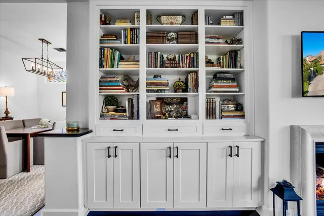 a room with a bookshelf a desk and a book shelf