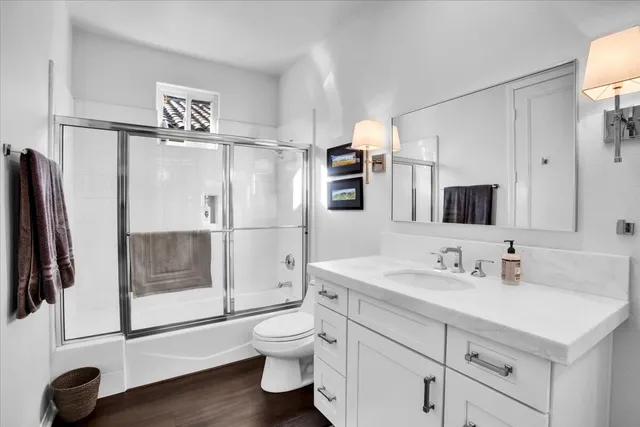 a bathroom with a sink toilet and shower