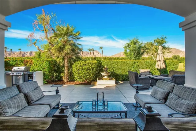 a view of a patio with couches and potted plants