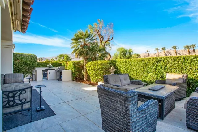 a view of a terrace with furniture and a fire pit