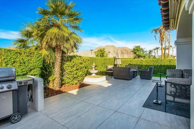 a view of a patio with a table and chairs