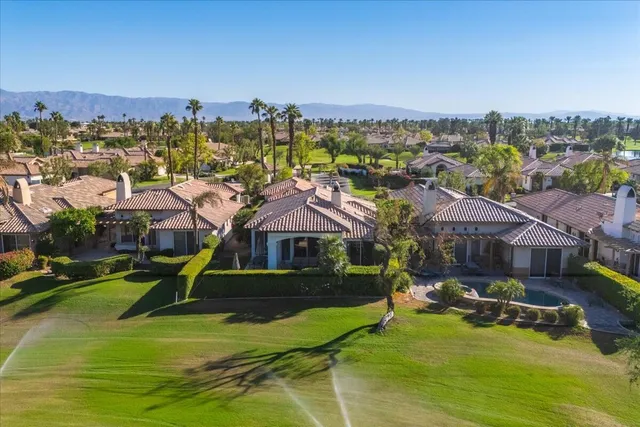 an aerial view of a house with swimming pool garden and patio