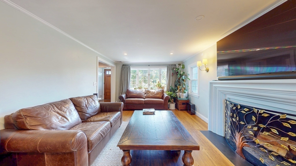 49 Ripley Road Medford, MA 02155 - Photo 13 of 27 a living room with furniture a flat screen tv and a fireplace