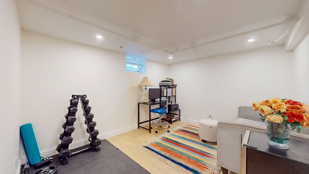 49 Ripley Road Medford, MA 02155 - Photo 19 of 27 a room with furniture and gym equipment