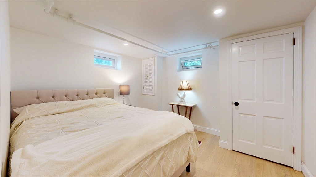 49 Ripley Road Medford, MA 02155 - Photo 20 of 27 a bedroom with a bed and a night stand