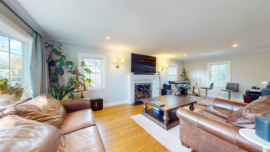 49 Ripley Road Medford, MA 02155 - Photo 2 of 27 a living room with furniture fireplace and a large window