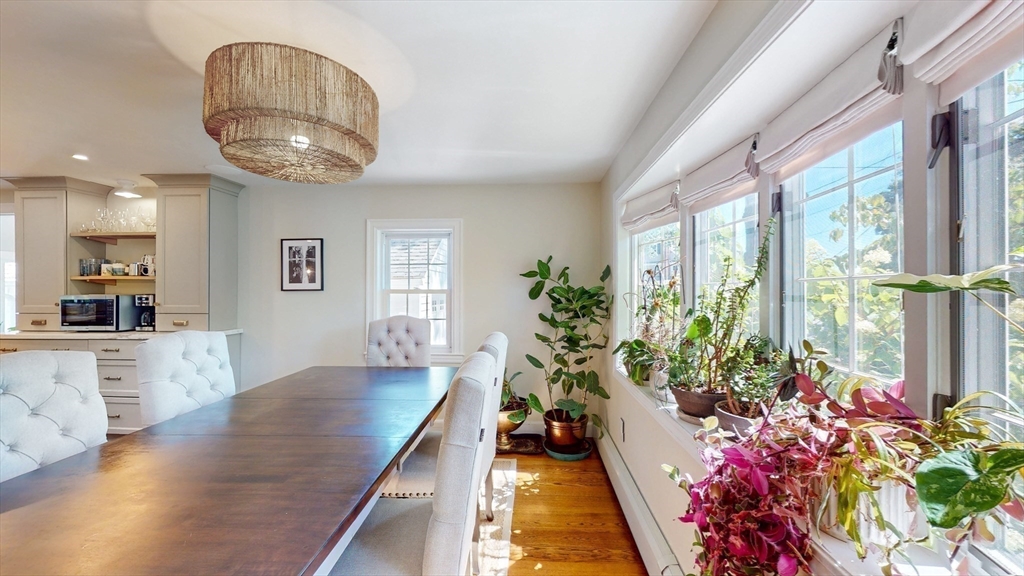 49 Ripley Road Medford, MA 02155 - Photo 9 of 27 a room with wooden floor and large windows