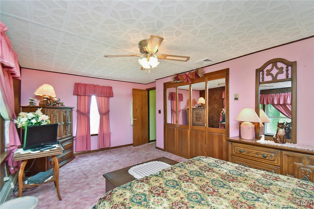 3015 Mountain Road Slatington, PA 18080 - Photo 23 of 32 a bedroom with a bed and a chandelier