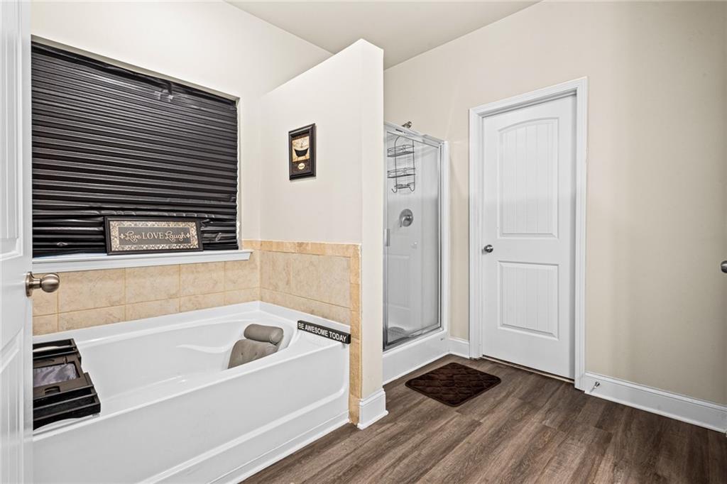 61 North Village Circle Rydal, GA 30171 - Photo 12 of 18 a bathroom with a bathtub and a shower