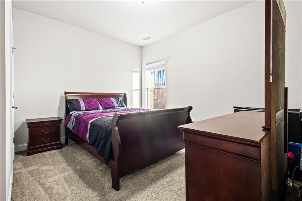 61 North Village Circle Rydal, GA 30171 - Photo 13 of 18 a bedroom with a bed and a dresser