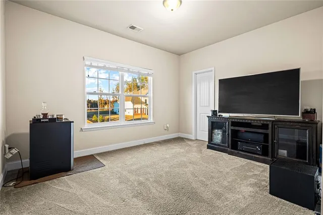 a room with furniture and flat screen tv