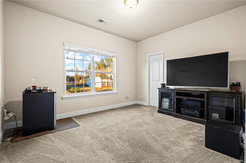 61 North Village Circle Rydal, GA 30171 - Photo 17 of 18 a room with furniture and flat screen tv