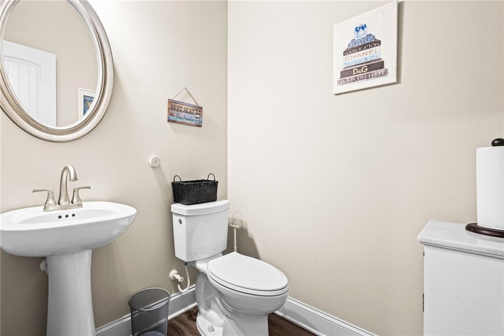 61 North Village Circle Rydal, GA 30171 - Photo 4 of 18 a bathroom with a toilet a sink and a mirror