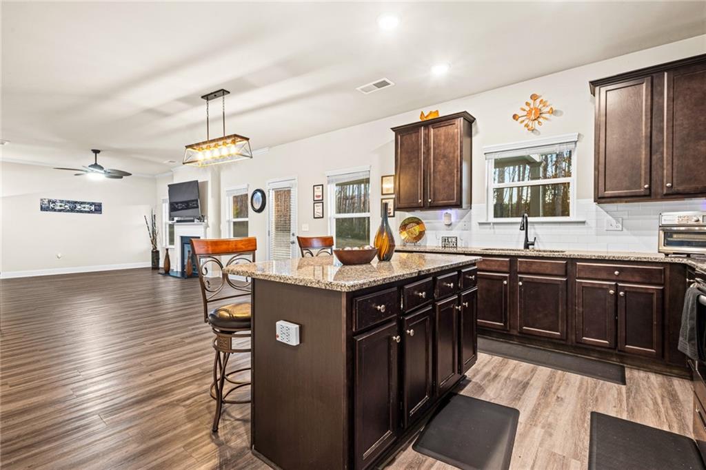 61 North Village Circle Rydal, GA 30171 - Photo 7 of 18 a kitchen with stainless steel appliances granite countertop a sink stove and wooden cabinets