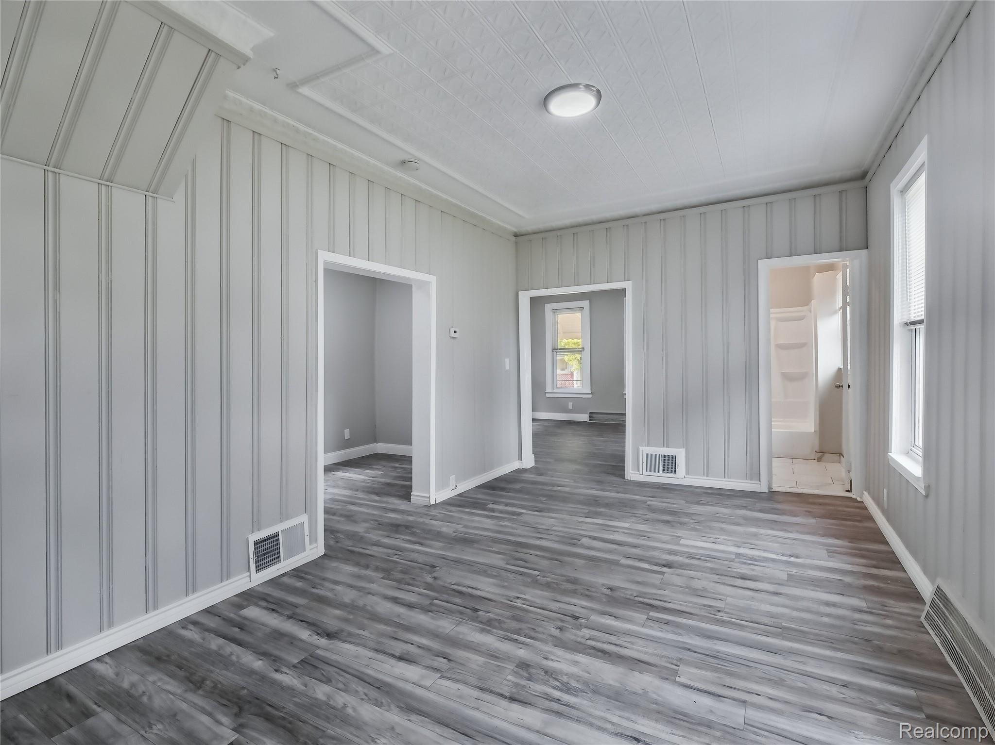 8220 Hudson Avenue Warren, MI 48089 - Photo 7 of 28 Spare room with wood finished floors and baseboards