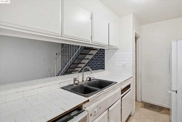 a kitchen with a sink and cabinets