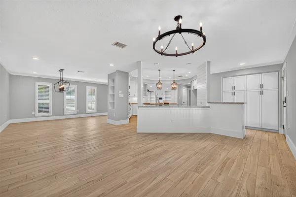 a view of a kitchen with wooden floor and a sink