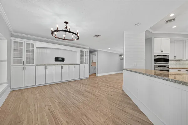 a view of a kitchen with wooden floor and window