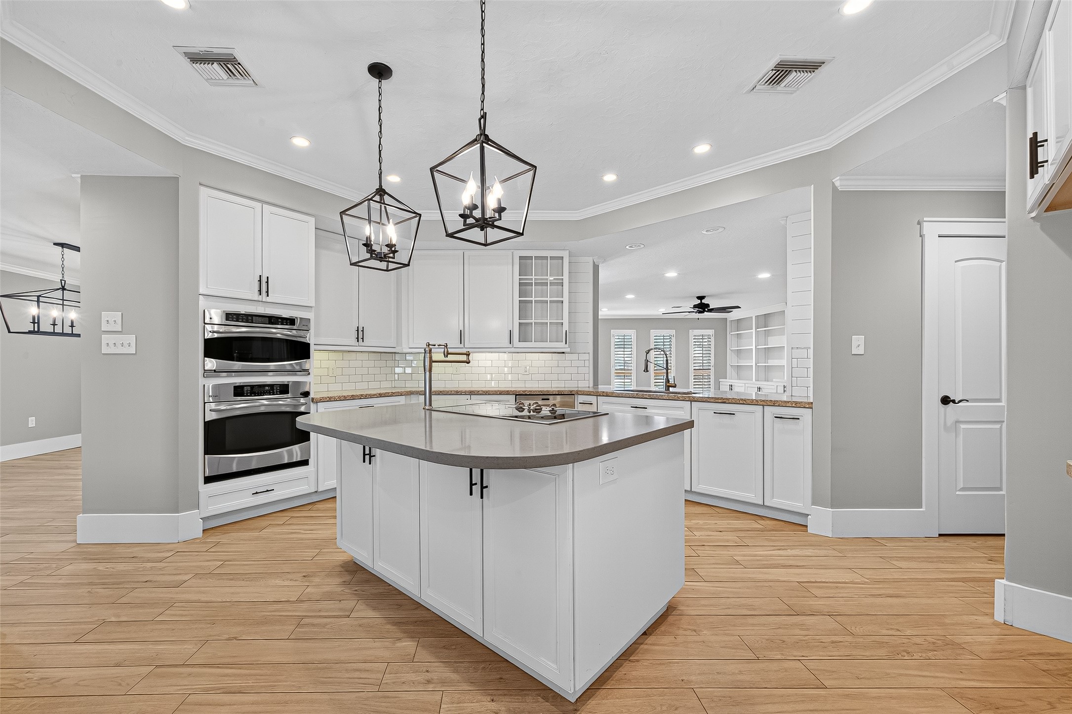 3115 Eula Morgan Road Katy, TX 77493 - Photo 13 of 36 a kitchen with stainless steel appliances kitchen island a large counter space and wooden floor