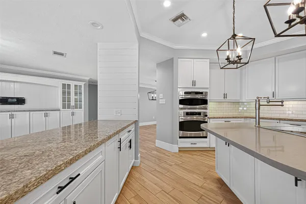 a kitchen with stainless steel appliances granite countertop a stove and cabinets