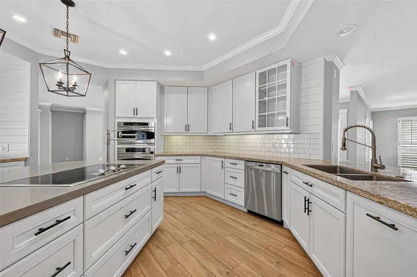 a kitchen with cabinets appliances and a sink