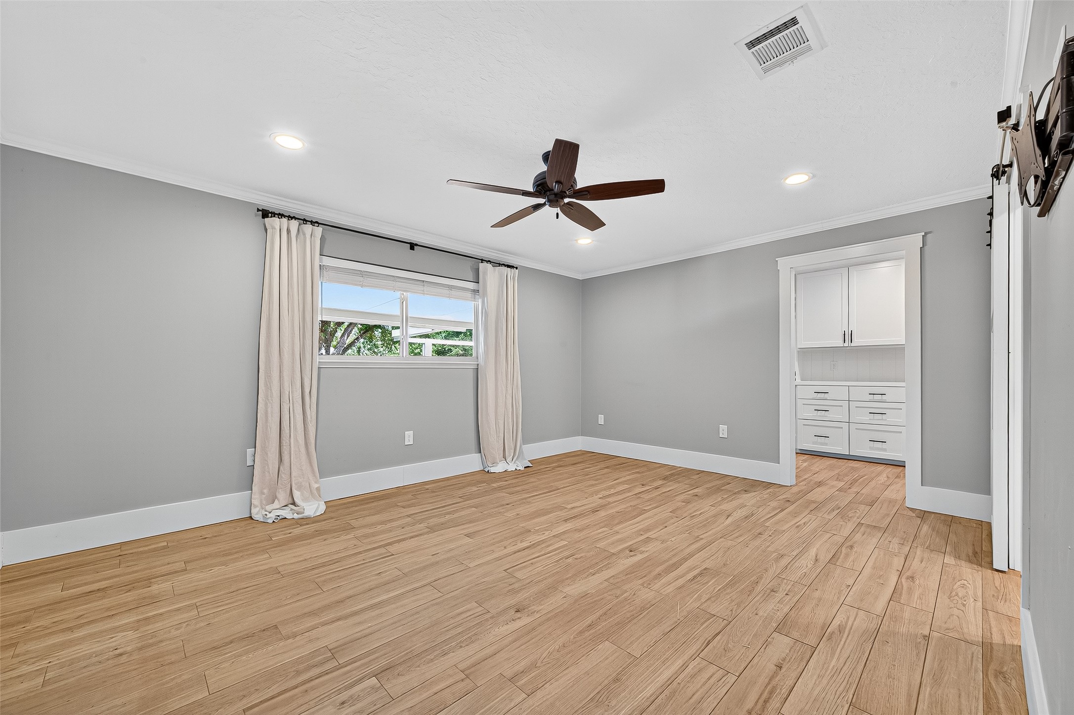 3115 Eula Morgan Road Katy, TX 77493 - Photo 17 of 36 a view of an empty room with a window and wooden floor