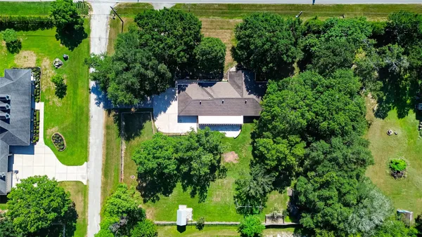 an aerial view of a house with a garden and trees
