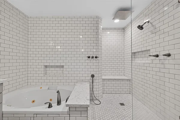 a bathroom with a bathtub and shower