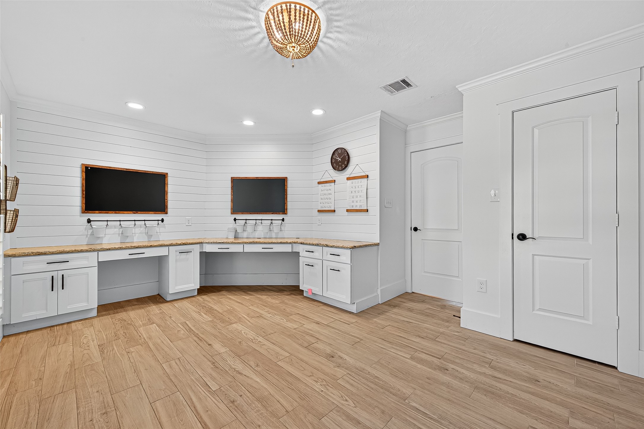 3115 Eula Morgan Road Katy, TX 77493 - Photo 26 of 36 a large white kitchen with stainless steel appliances wooden floor and chandelier