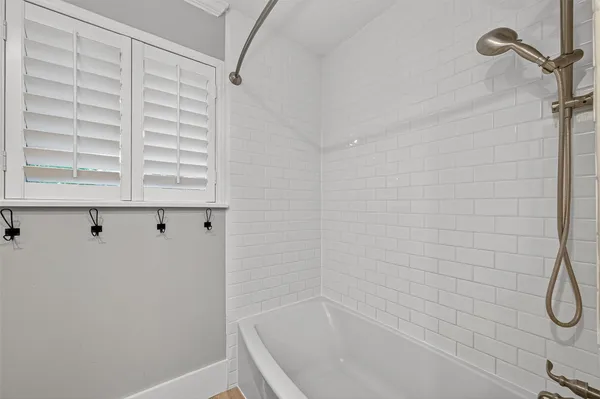 a bathroom with a bathtub and shower