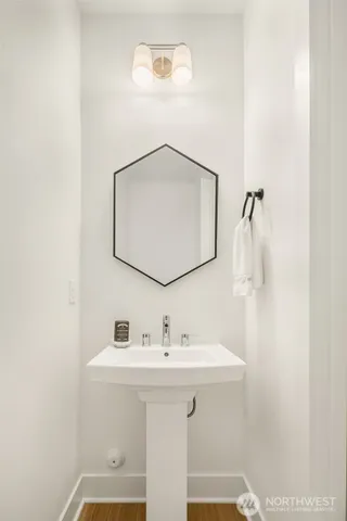 a bathroom with a sink a mirror and vanity