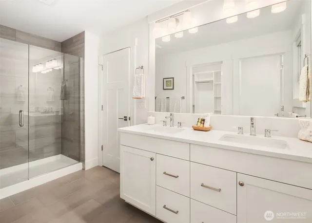 a bathroom with double sink and a mirror