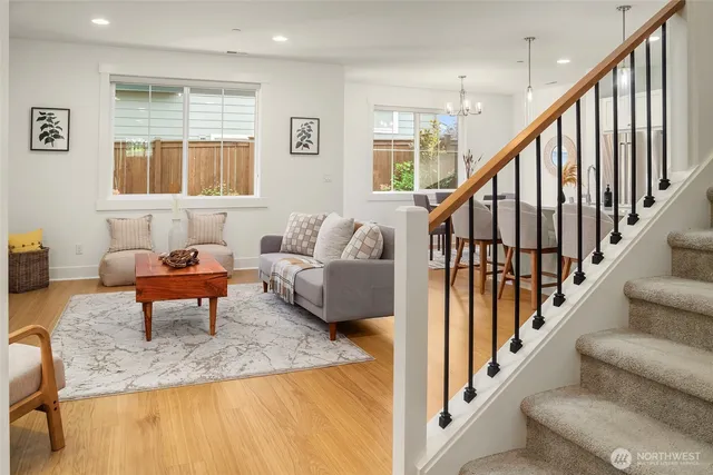 a living room with furniture and a hard wood floor