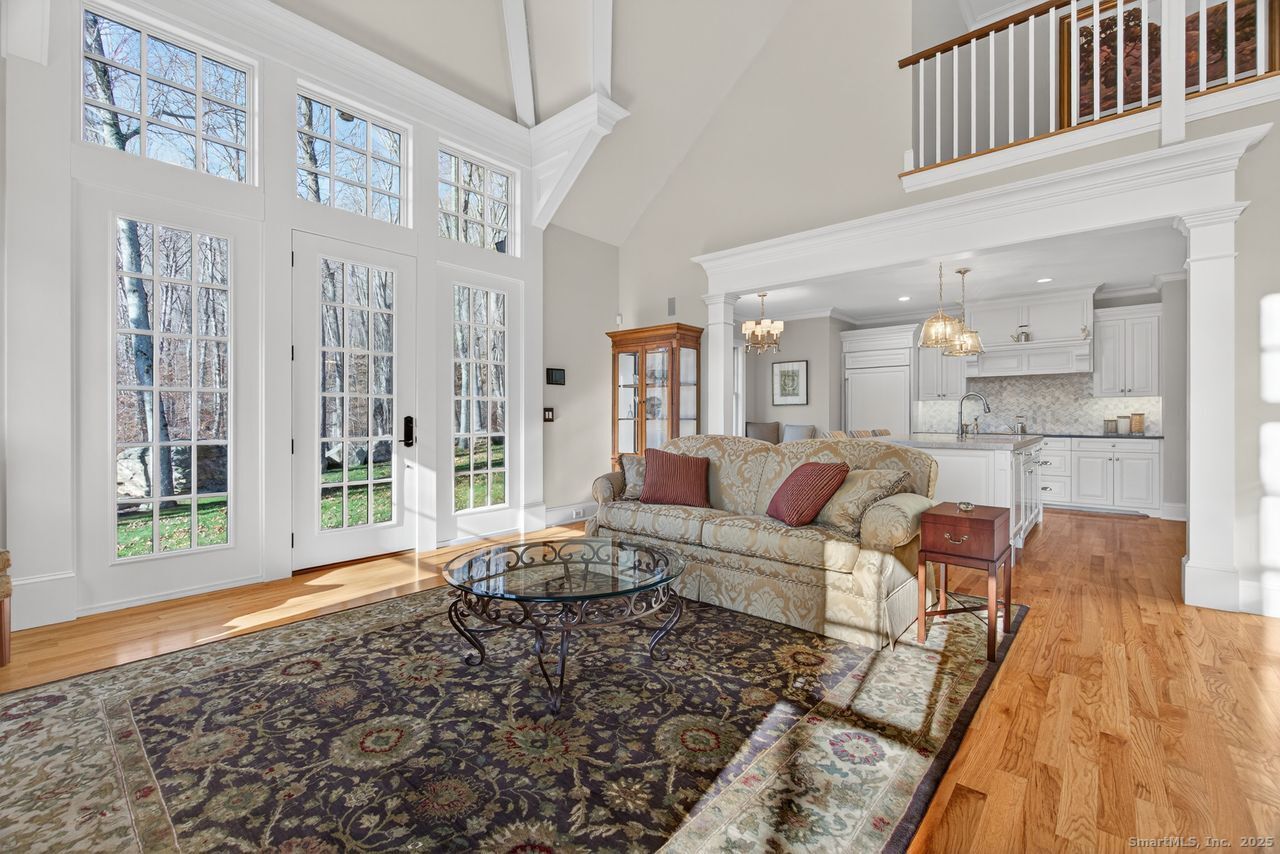401 Fox Hopyard Road East Haddam, CT 06423 - Photo 11 of 38 a living room with furniture wooden floor and a large window