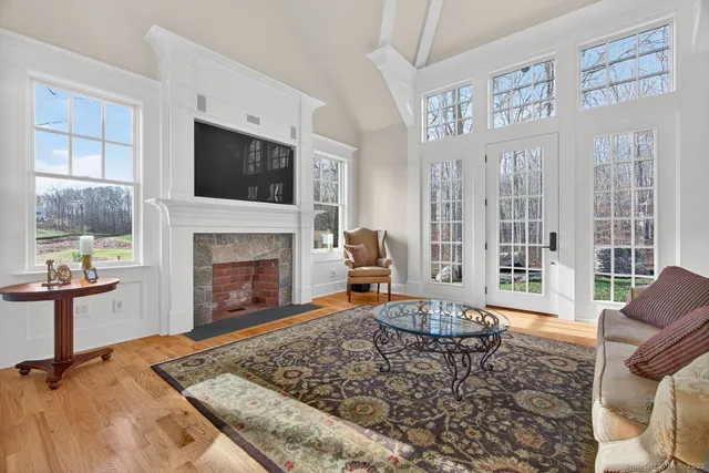 a living room with furniture a flat screen tv and a fireplace