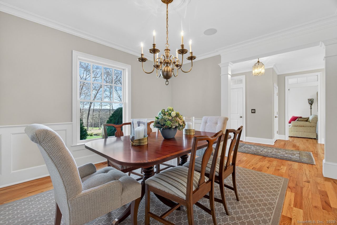 401 Fox Hopyard Road East Haddam, CT 06423 - Photo 15 of 38 a view of a dining room with furniture a chandelier and wooden floor